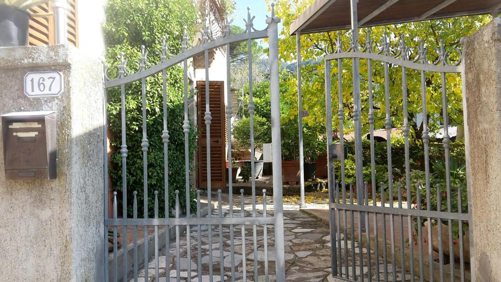 an iron gate with a sign on it next to a yard at Gessy's in Lucca