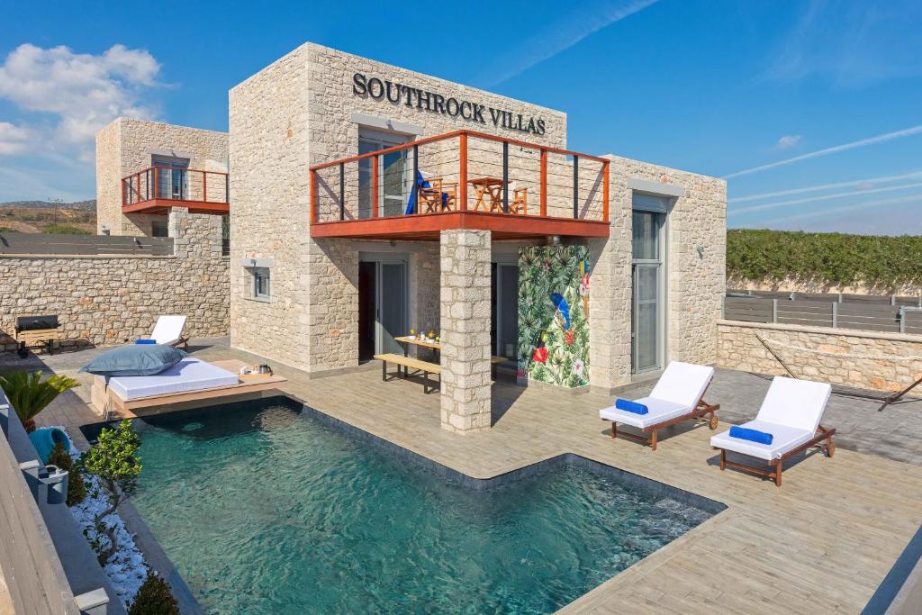 a villa with a swimming pool and a balcony at Southrock Villas in Lachania