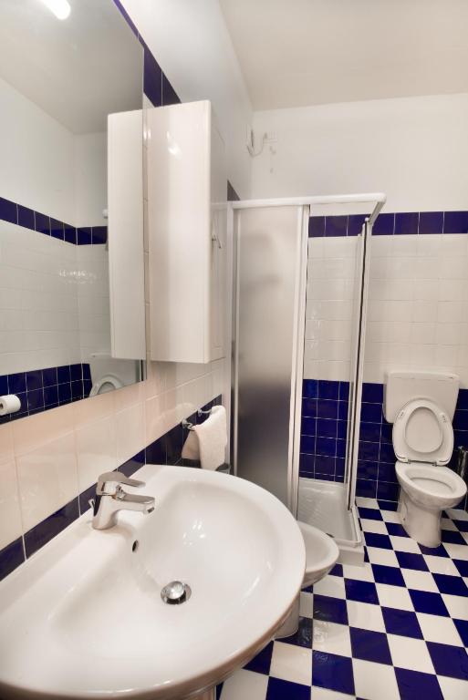 a bathroom with a sink and a toilet at Hotel Villa Olga in Caorle