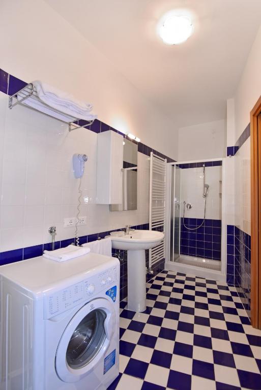 a washing machine in a bathroom with a sink at Hotel Villa Olga in Caorle
