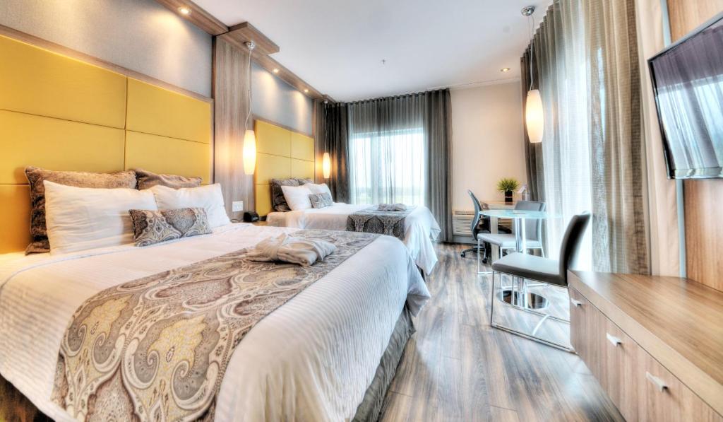 Postel nebo postele na pokoji v ubytování Hôtel Universel, Centre de congrès Rivière-du-Loup