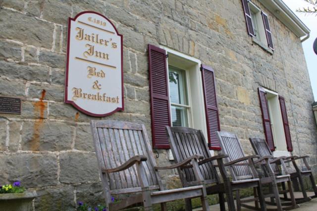 a group of chairs sitting outside of a building at Jailer's Inn in Bardstown