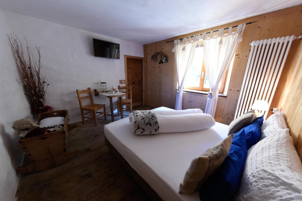 Postel nebo postele na pokoji v ubytování Agriturismo Baita De L'ALL