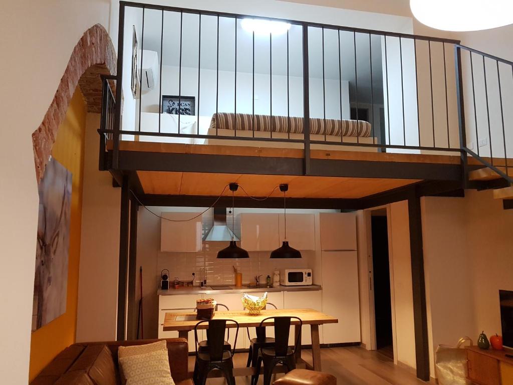 a living room with a wooden table and a balcony at Domus Navigli in Milan