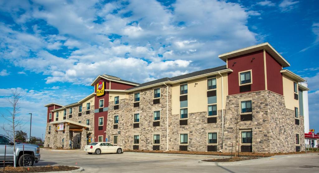 a hotel with a car parked in a parking lot at My Place Hotel-Altoona/Des Moines, IA in Altoona