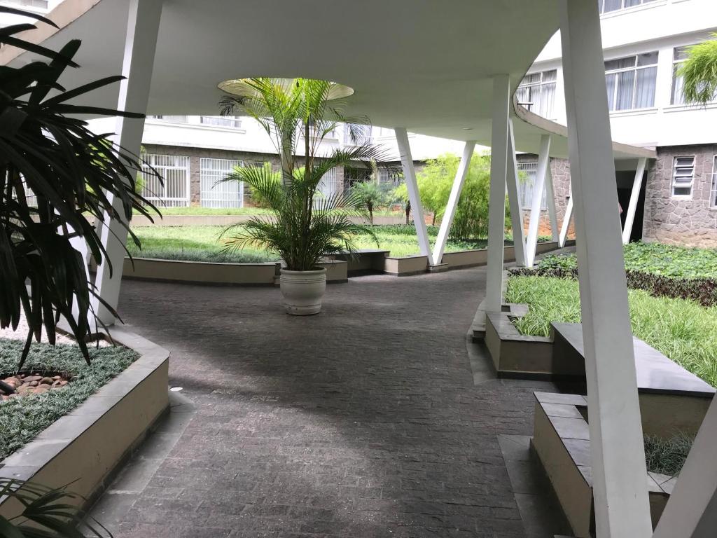 a courtyard with palm trees in a building at Loft at Paulista Avenue (no coração de S.Paulo) in São Paulo