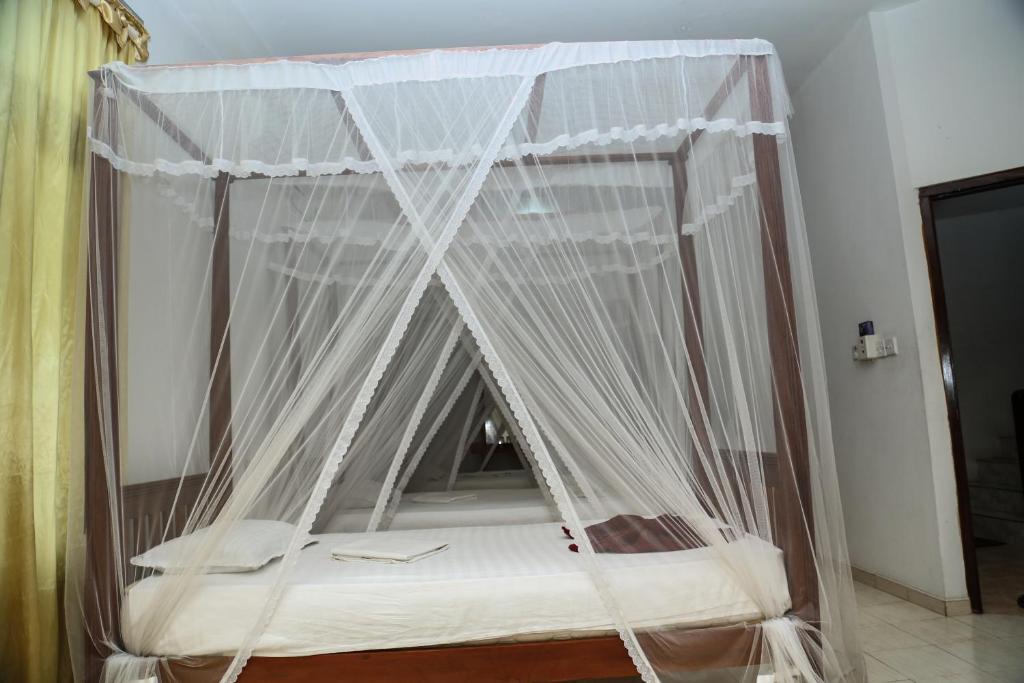 Postel nebo postele na pokoji v ubytování Resort Deepika Mirissa