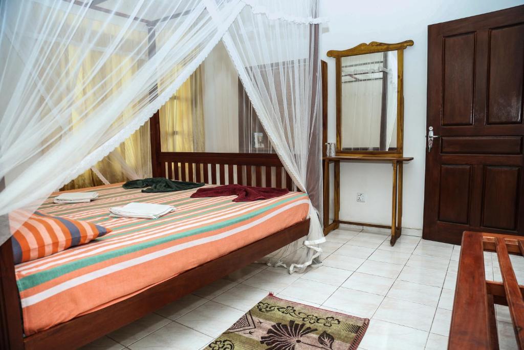 Postel nebo postele na pokoji v ubytování Resort Deepika Mirissa