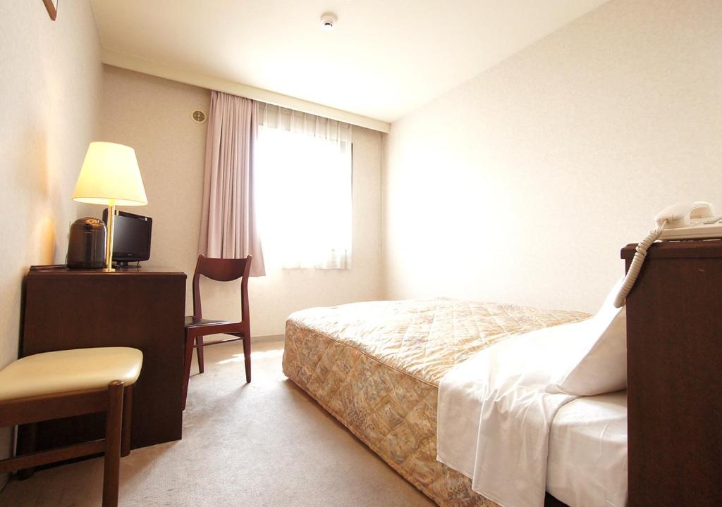 Postel nebo postele na pokoji v ubytování Hotel Trend Matsumoto