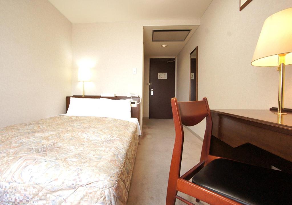 Postel nebo postele na pokoji v ubytování Hotel Trend Matsumoto
