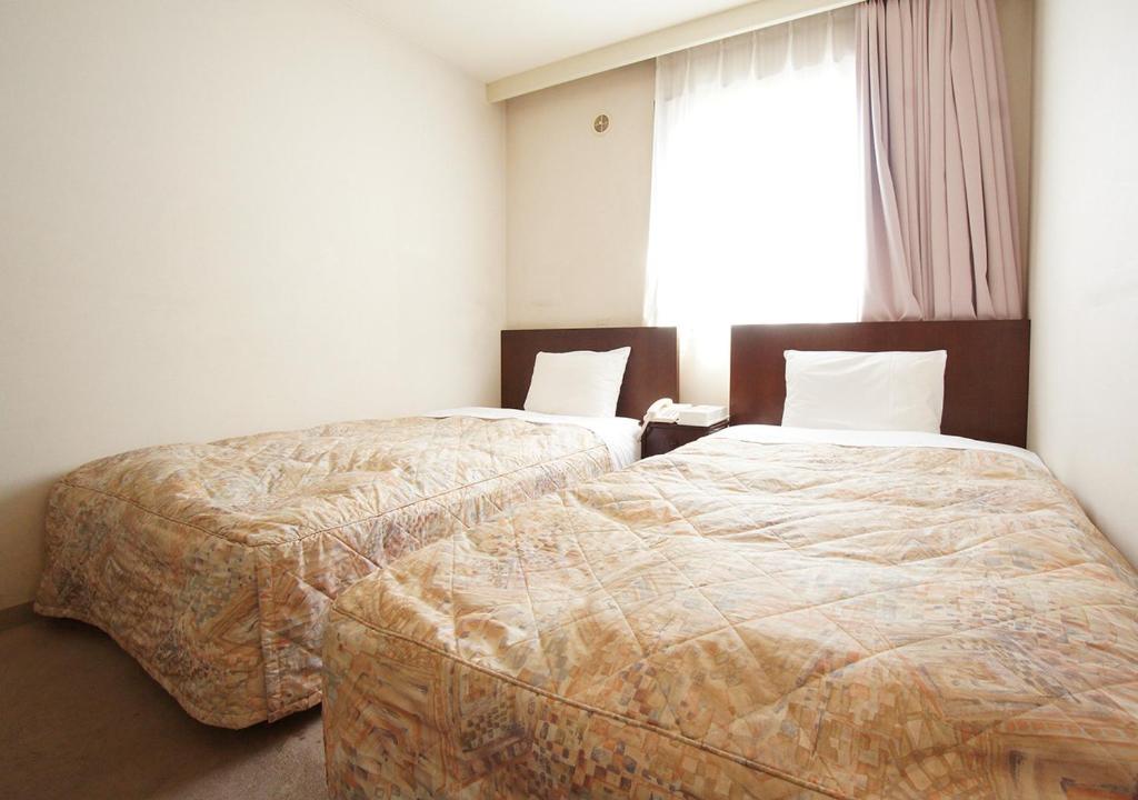 Postel nebo postele na pokoji v ubytování Hotel Trend Matsumoto