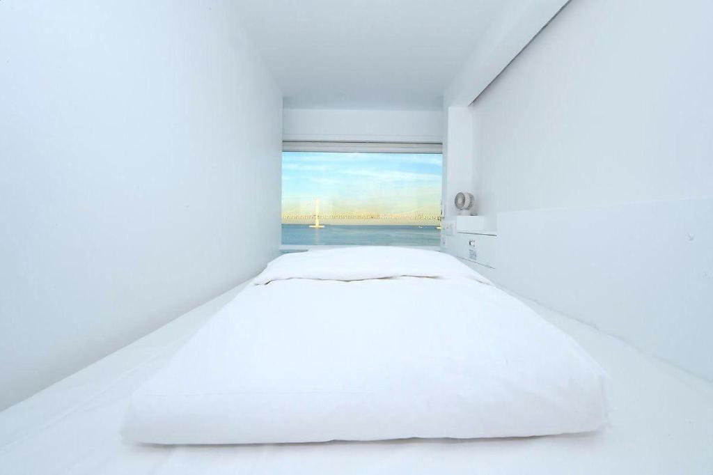 Postel nebo postele na pokoji v ubytování Gwanganli Hotel 1