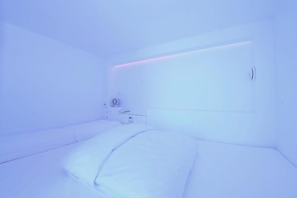 Postel nebo postele na pokoji v ubytování Gwanganli Hotel 1