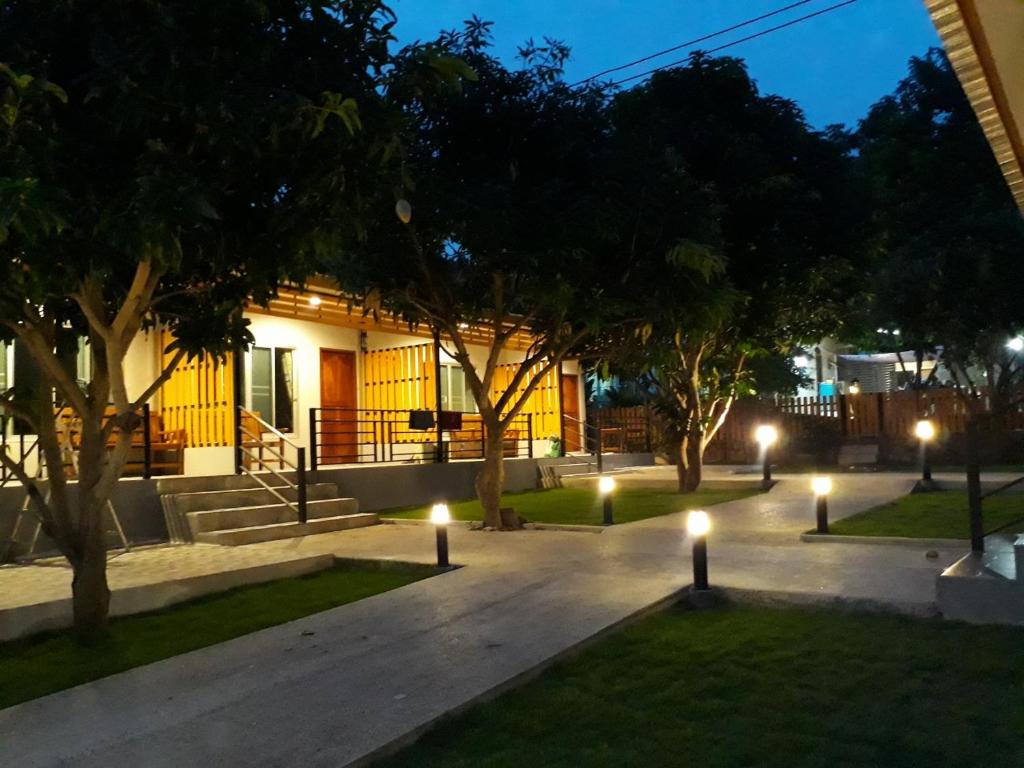 a courtyard with lights in front of a building at Green Mango Resort in Nong Prue