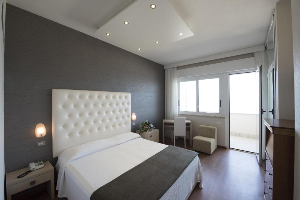 Postel nebo postele na pokoji v ubytování Hotel Benini