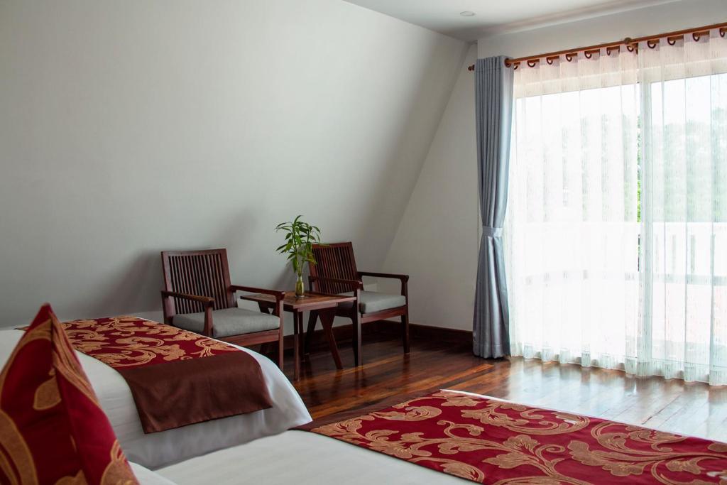 Postel nebo postele na pokoji v ubytování Zita Angkor Hotel