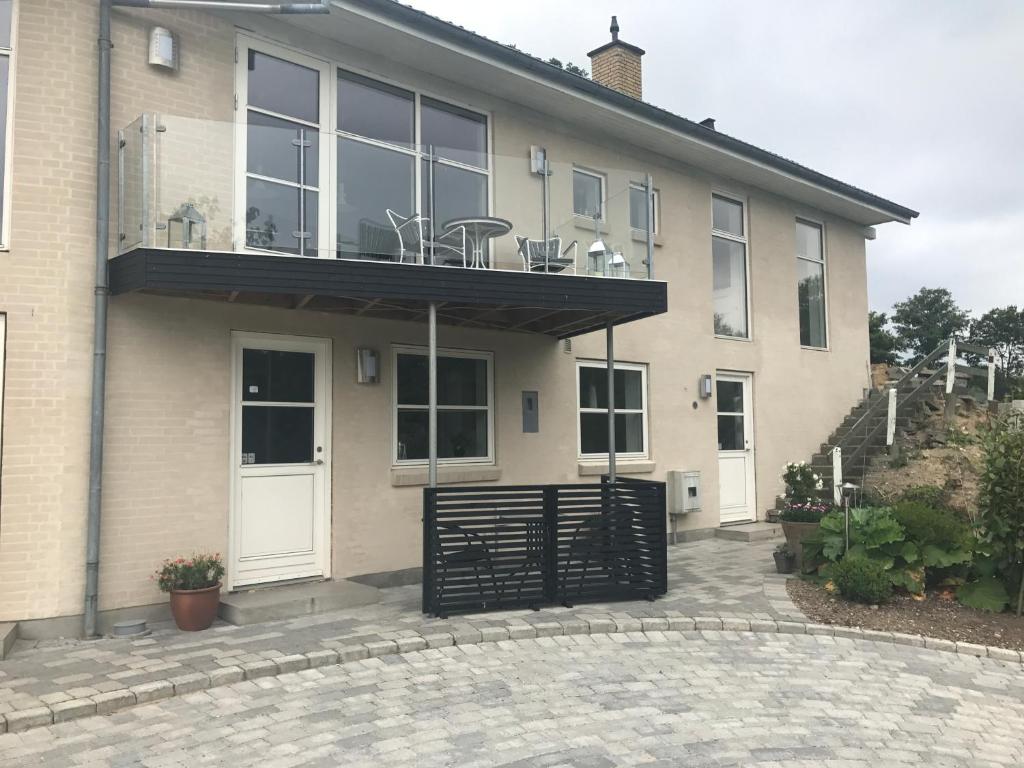 a house with a black gate and a balcony at Julsø lejligheden in Silkeborg