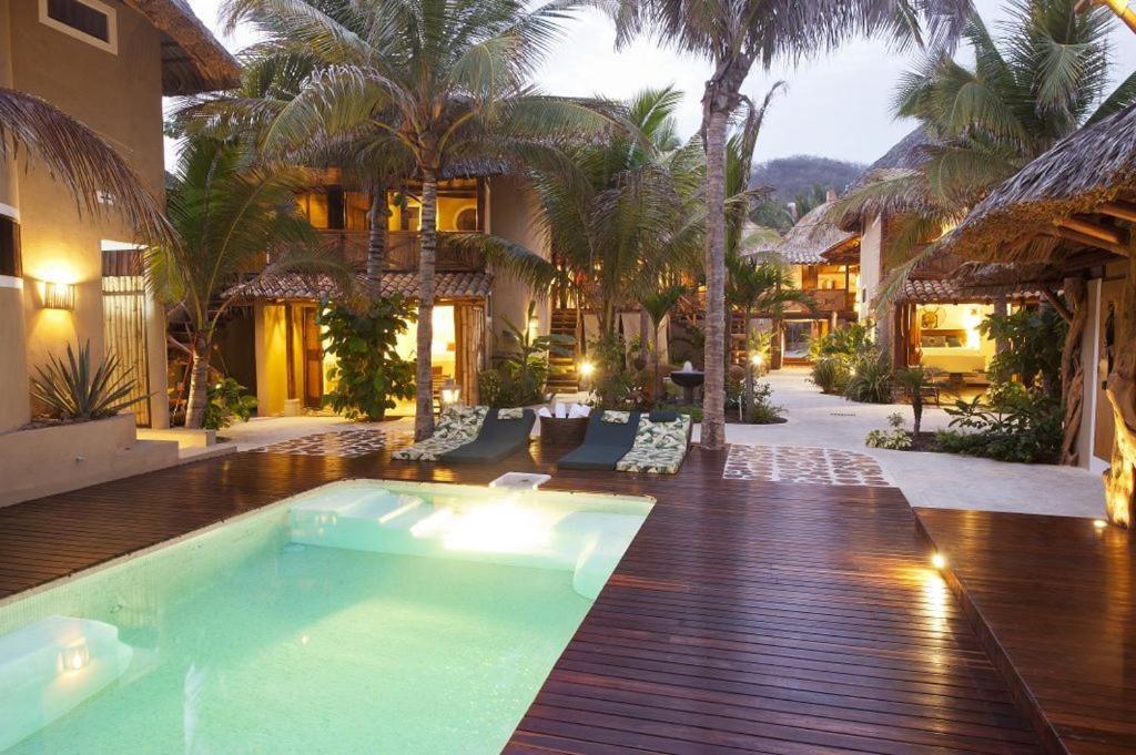 a swimming pool in the middle of a house at Aamori Boutique Hotel (Only Adults) in San Agustinillo