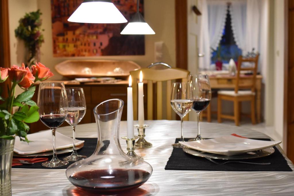 a table with glasses of wine on a table at Ferienwohnung Casa da Maria in Langelsheim