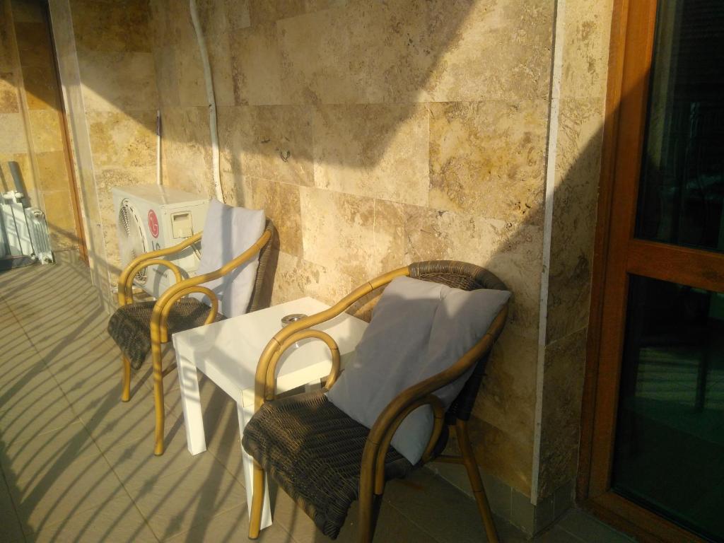 two chairs and a table on a balcony at Apartment Budapeshta in Sofia