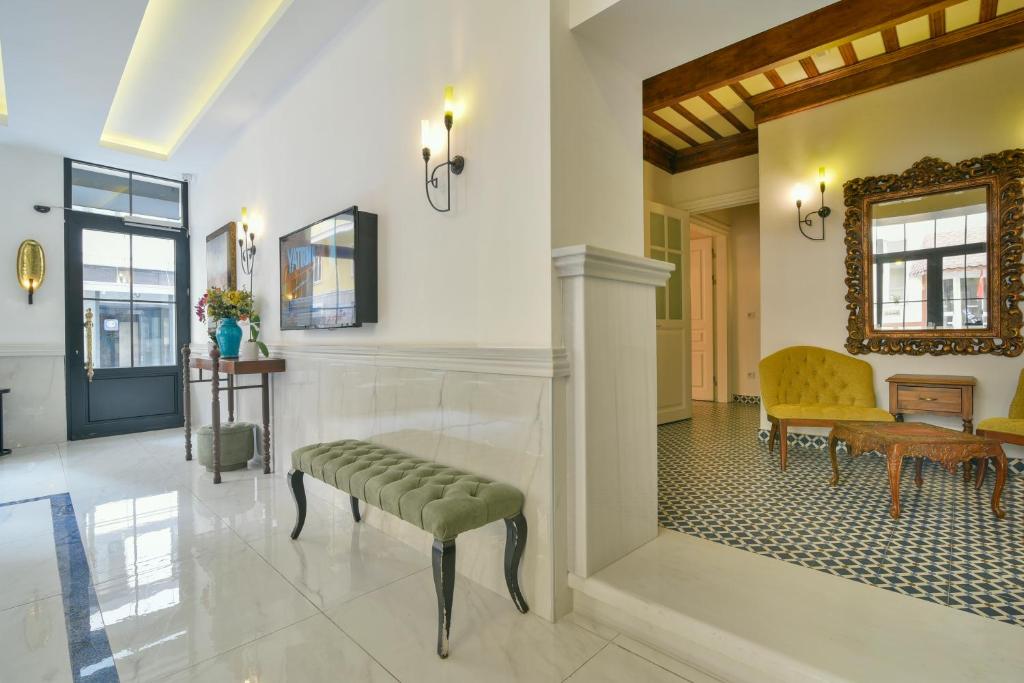 a living room with a bench and a mirror at Istanbul Life Hotel in Istanbul