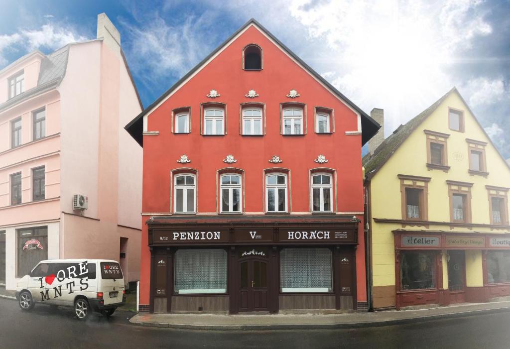 a red building on the side of a street at Penzion V Horách in Kraslice