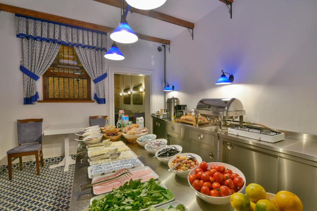a kitchen with a table with many bowls of food at Istanbul Life Hotel in Istanbul