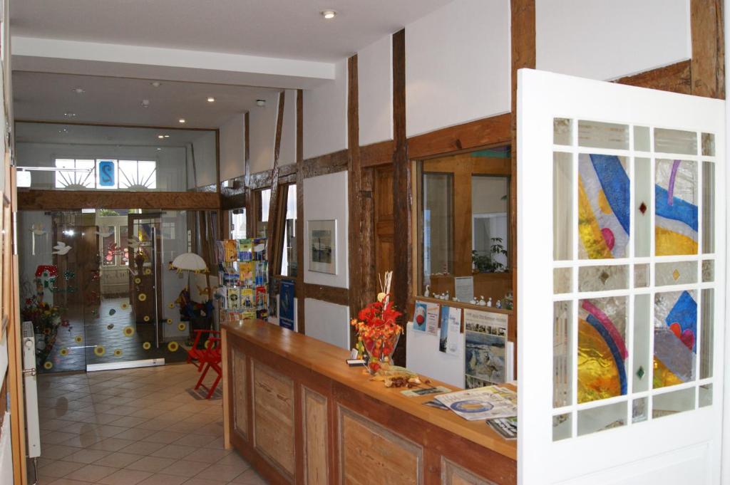 a room with a counter with flowers in a room at Hotel Peenebrücke in Wolgast