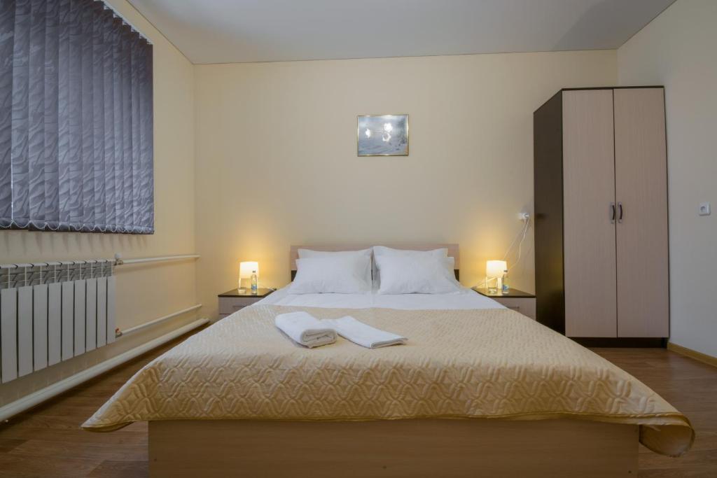 Кровать или кровати в номере Отель Мандарин