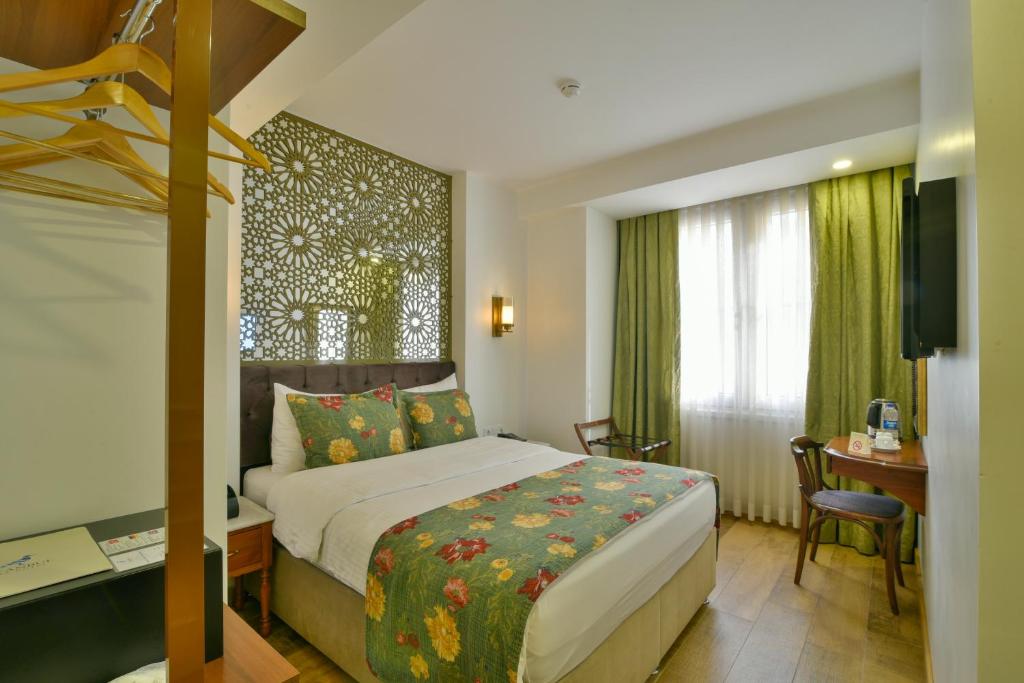 a hotel room with a bed and a desk and a television at Istanbul Life Hotel in Istanbul