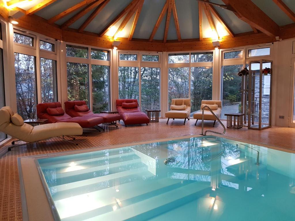 a swimming pool in a house with windows at Villa Schwarzwald in Schluchsee