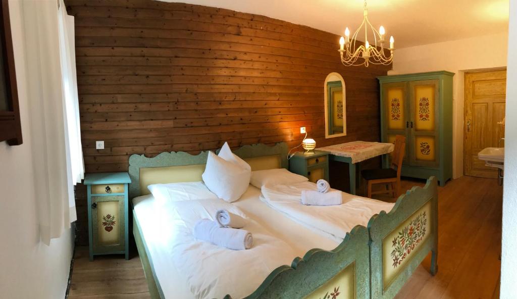 a bedroom with a large bed with two pillows on it at Ferienhaus Dorfschmiede in Neustift im Stubaital
