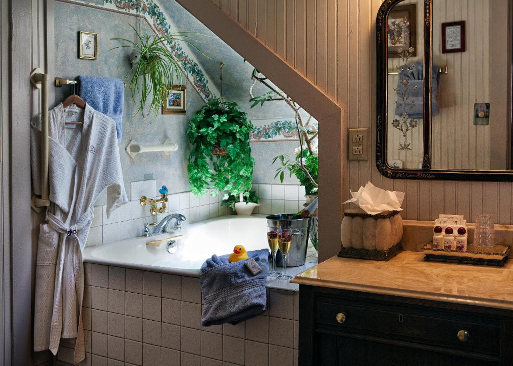 a bathroom with a sink and a bath tub at Holden House 1902 Bed & Breakfast Inn in Colorado Springs