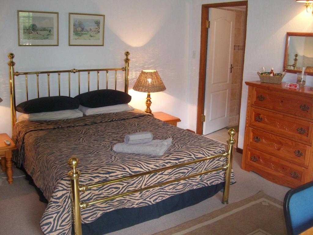 Кровать или кровати в номере Oaktree Lodge Guest House