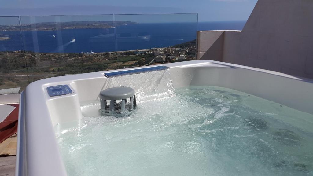 a bath tub with water pouring out of it at Angels' Place Aria in Nadur