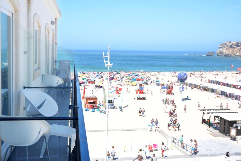 a view of a crowded beach from a building at Hotel Mar Bravo in Nazaré
