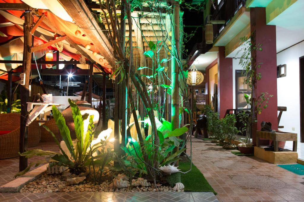 a room with a bunch of plants in a building at Bulskamp Inn in El Nido