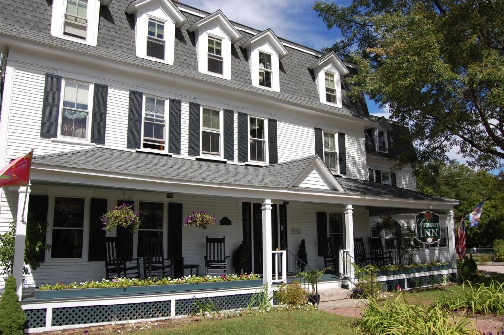 a white house with a black roof at Cranmore Inn and Suites, a North Conway boutique hotel in North Conway