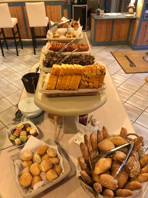 a buffet of different types of food on a table at Hôtel Le Peu Breton in Sainte-Marie-de-Ré