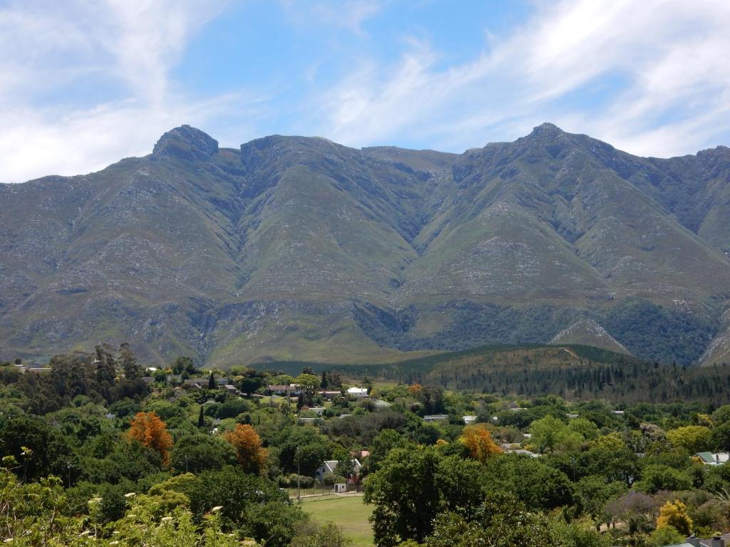 a view of a mountain range with a town and trees at Mountain View Swellendam in Swellendam