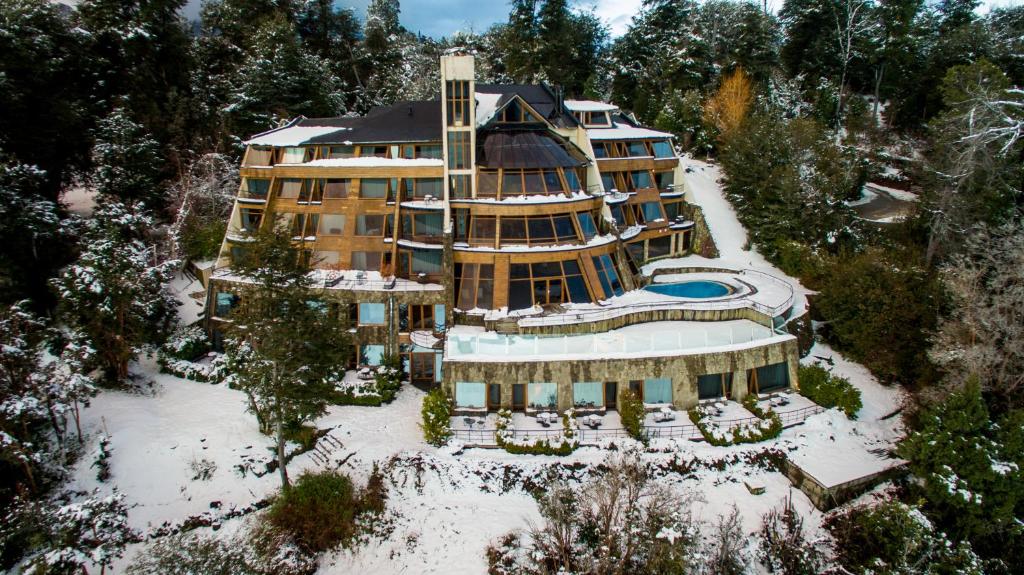 an aerial view of a large building in the snow at Sol Arrayan Hotel & Spa in Villa La Angostura