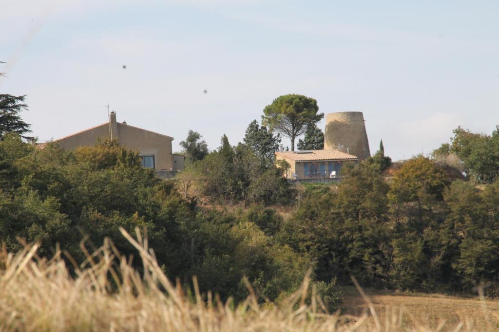 a house on top of a hill with a silo at La Bleuette in Montmaur