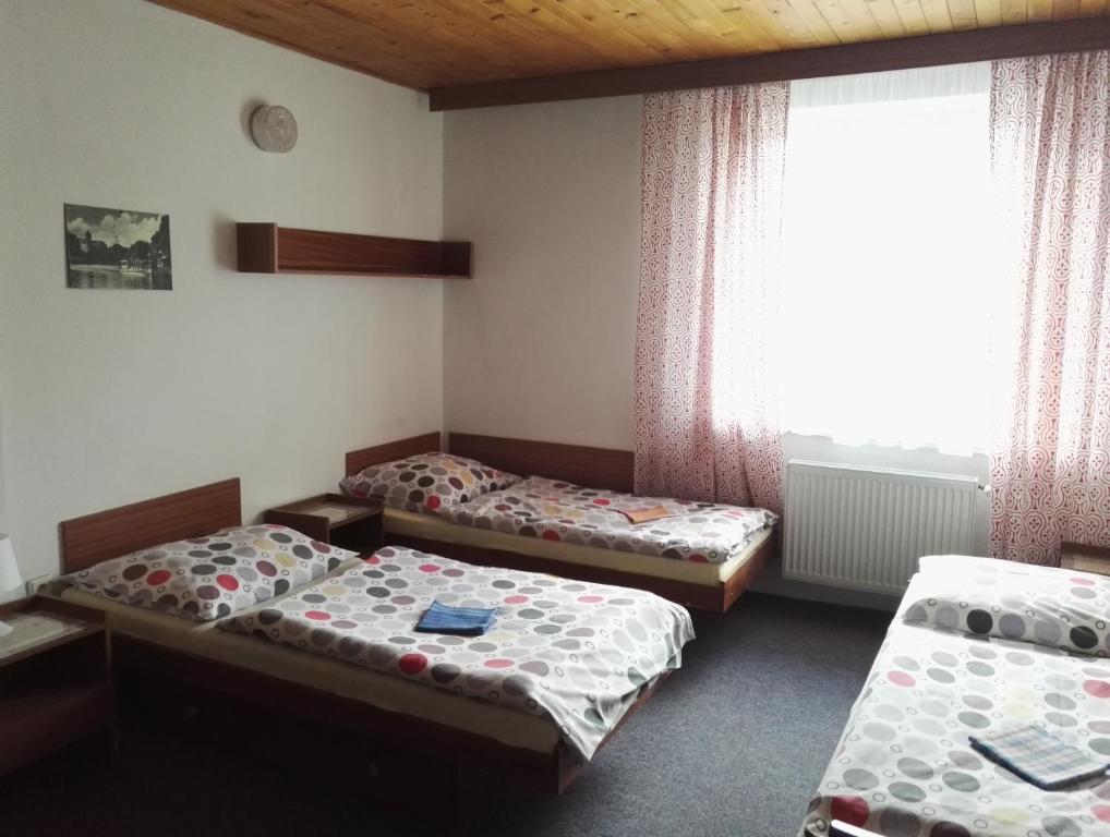Postel nebo postele na pokoji v ubytování Penzion Tenis