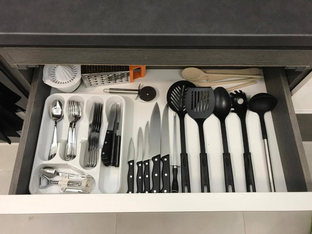 a drawer with forks and spoons and utensils at Manyi Apartman in Debrecen