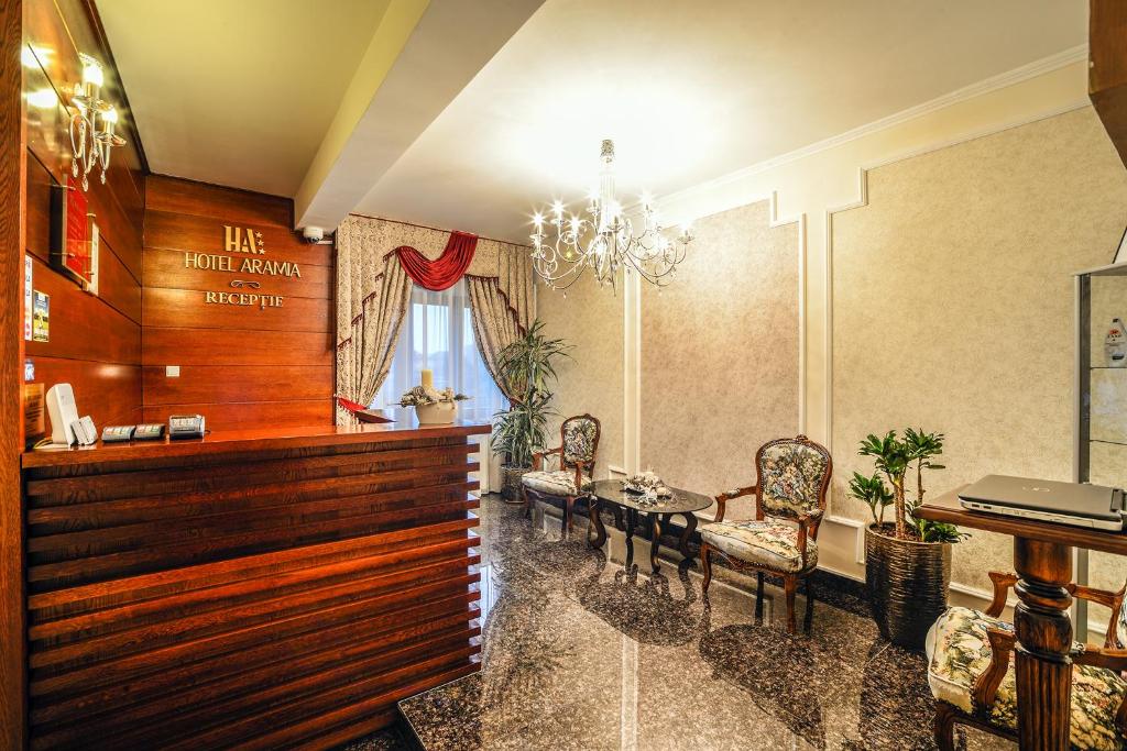 a waiting room with a table and chairs at Hotel Aramia in Satu Mare