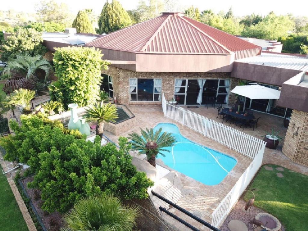 an aerial view of a house with a swimming pool at Leach Lodge in Kuruman