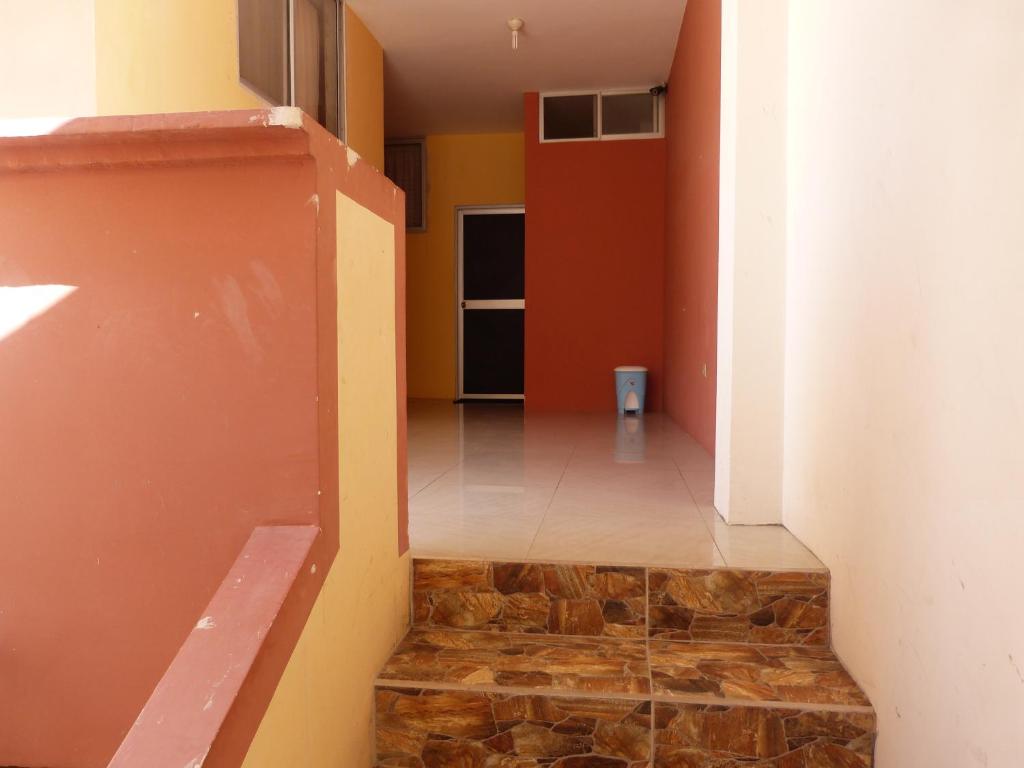 a hallway with a stone floor and a staircase at Hostal Terito in Puerto Baquerizo Moreno