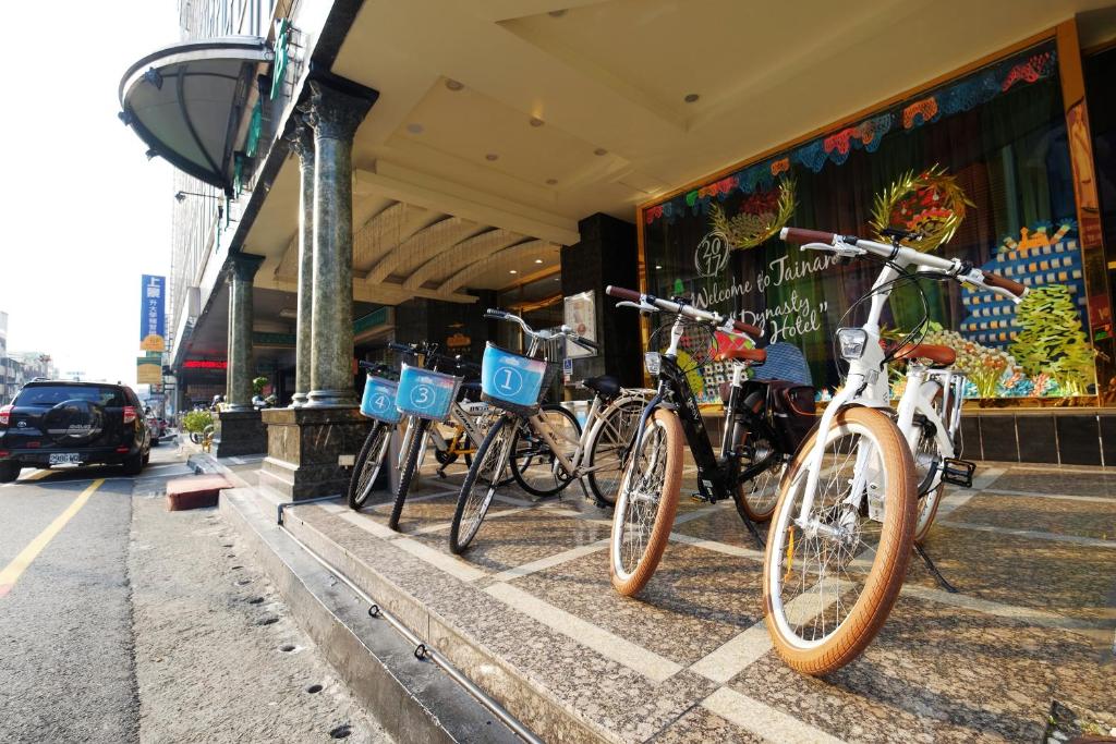 a group of bikes parked in front of a store at Dynasty Hotel in Tainan