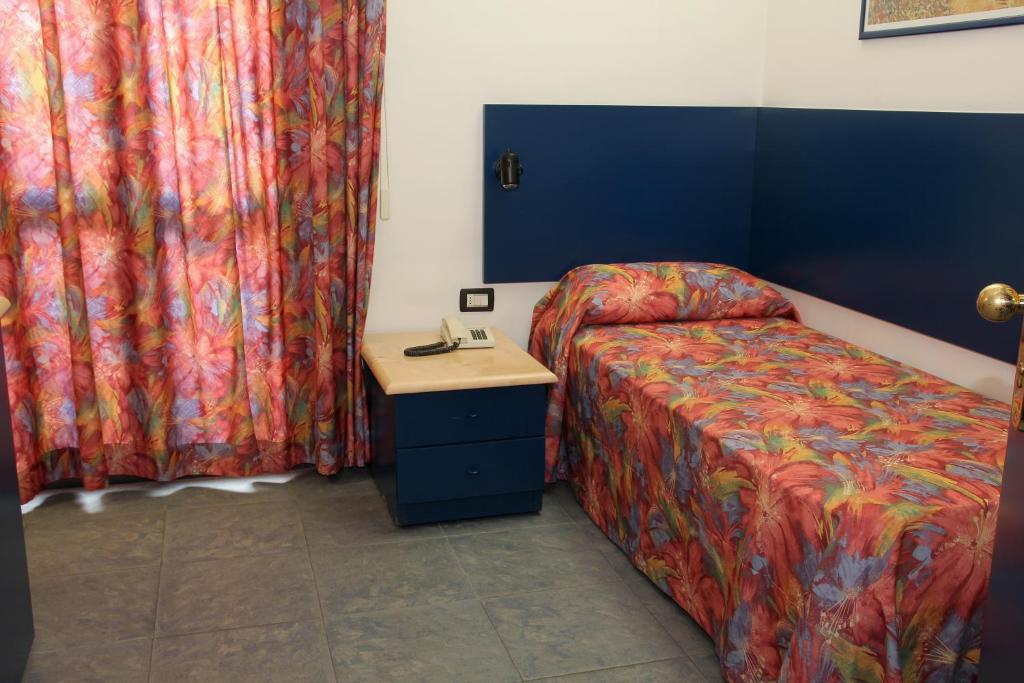 Postel nebo postele na pokoji v ubytování Hotel Raphael