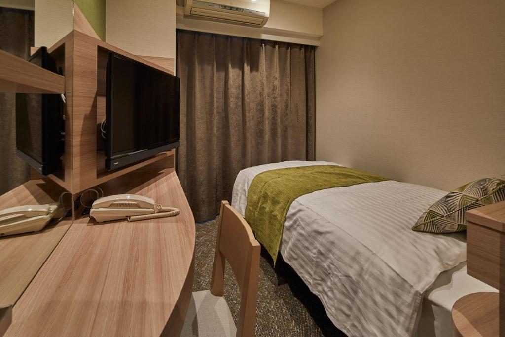 Postel nebo postele na pokoji v ubytování Fujinomiya Fujikyu Hotel